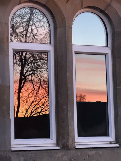 Sunset in the old schoolhouse windows